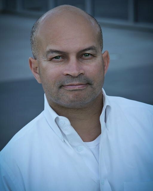 Geoff2016 (1) Man slightly smiling and in white collar shirt